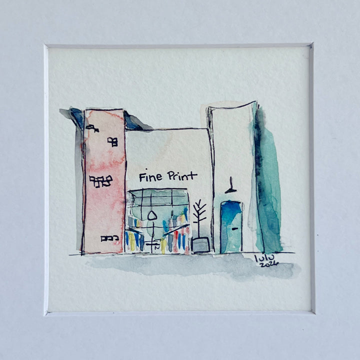 A framed watercolor architectural sketch of a storefront or building facade, with the words 'Fine Print' and 'July 2026' written in the artwork, shown against a light gray background.