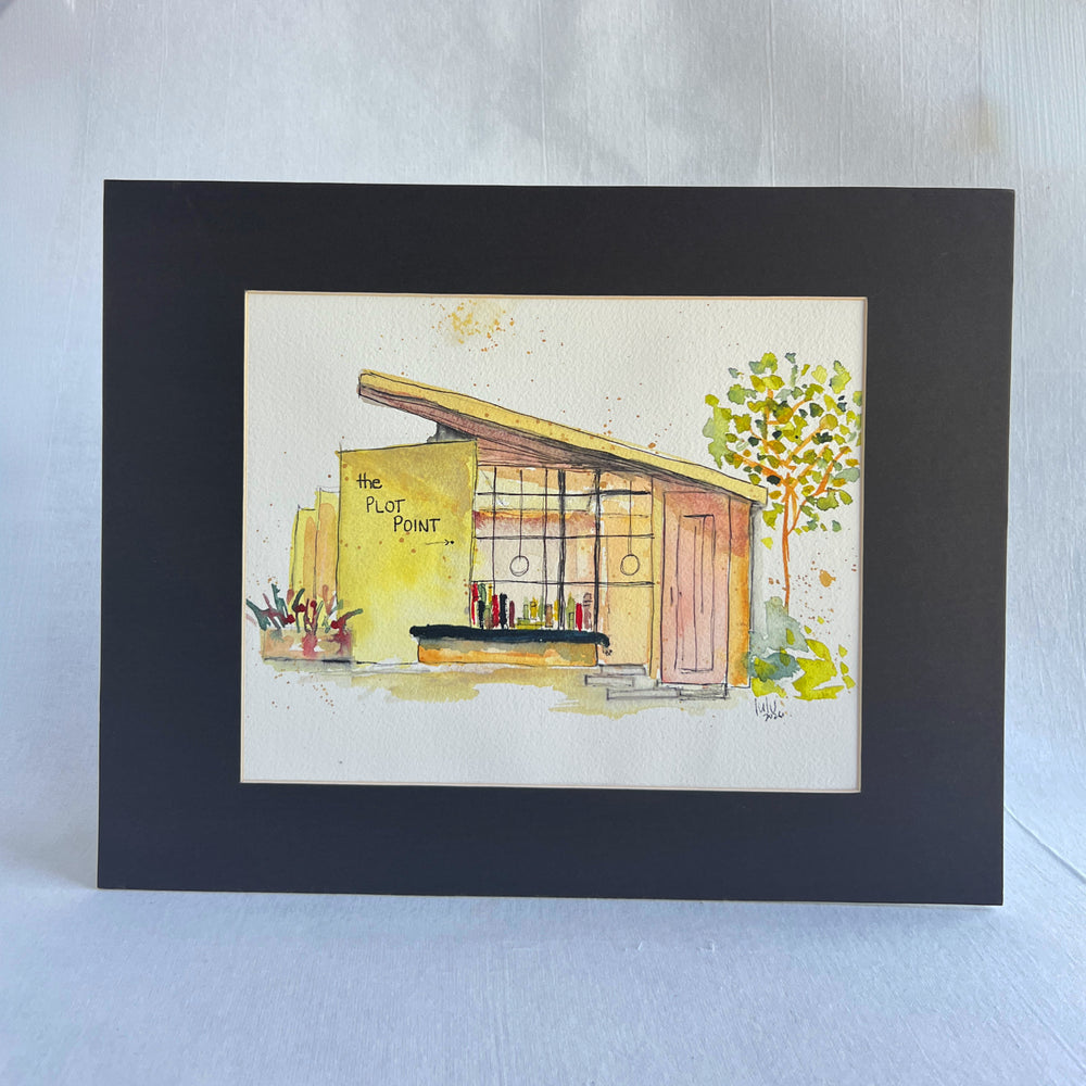 A watercolor painting of a midcentury modern bookstore with the text 'the PLOT POINT' on the yellow wall, shown on a white paper sheet against a dark navy background.