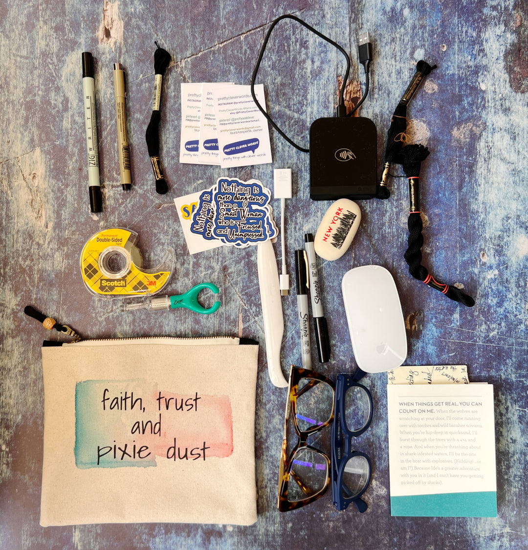 a canvas zip bag flat lay photo, with various office tools and products, designed to show how many items can fit into the bag.