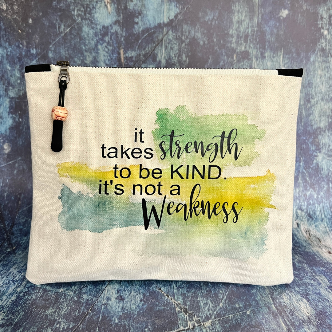 square canvas zipper pull bag with the words, it takes strength to be kind, it's not a weakness.