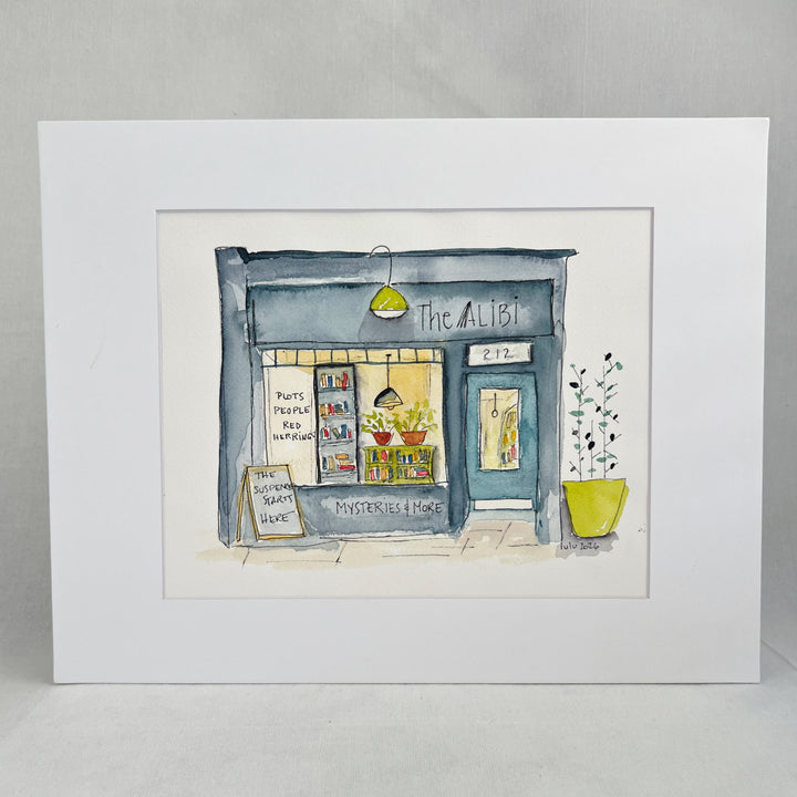 A watercolor-style illustration of a storefront named The Alibi, with the text 'Mysteries & More' at the bottom and a yellow planter with tall green stems on the right. The shop facade is blue-gray, the window display is warm yellow, and there are small red and orange plant pots inside.