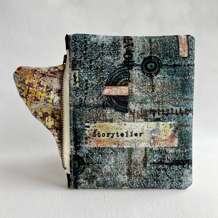 padded canvas zip bag with a blue  library card and the words, Fantasy Tales are not meant to tell us that monsters exist, but that they can be slayed, plus a colorful zipper pull and lining