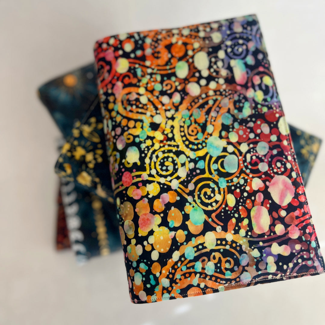 rectangular fabric book cover with rich paisley multicolored splatters and colors