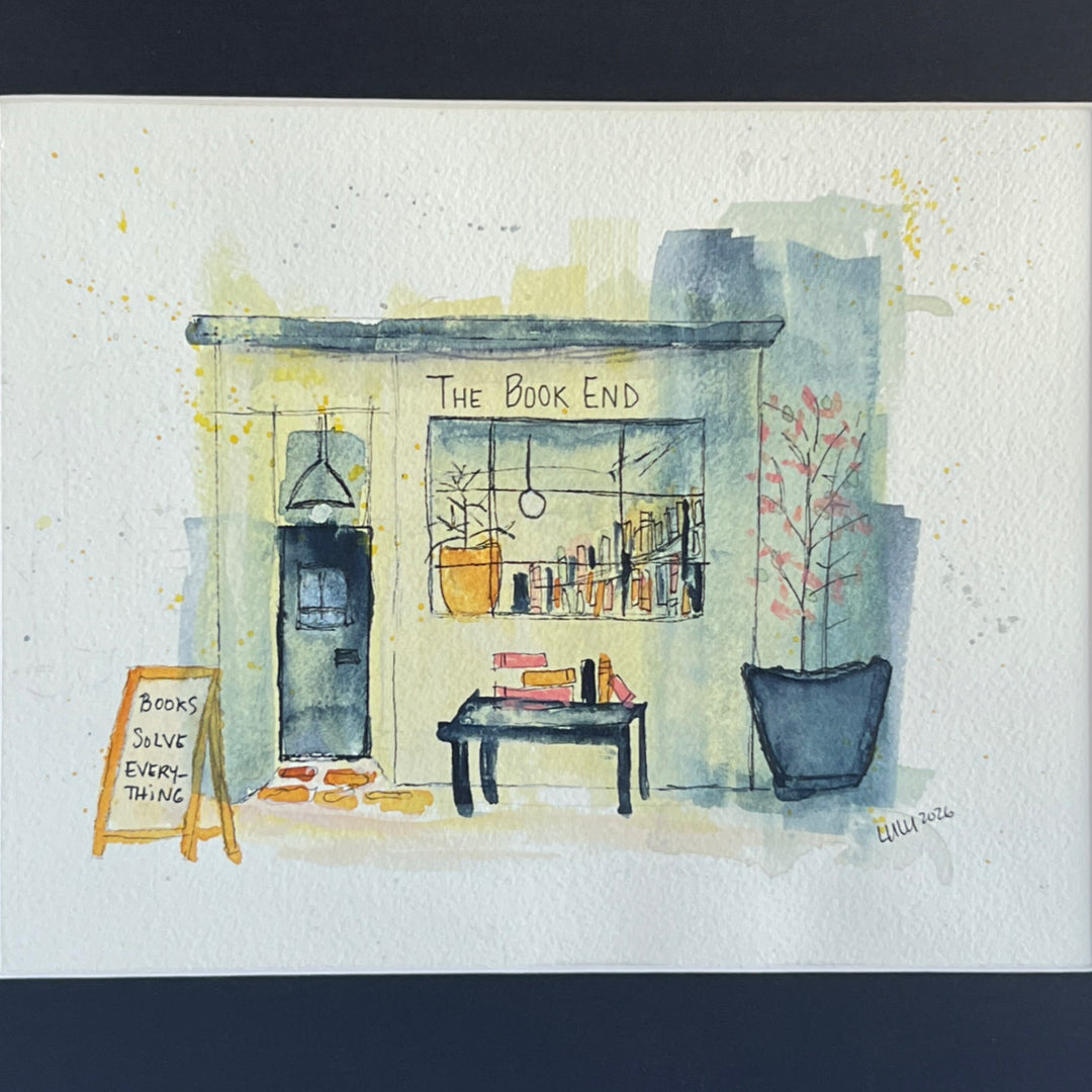 A watercolor painting of a mystery bookstore storefront labeled 'The Book End,' with a dark door, window display of books, a small table with books, potted plants, and a chalkboard sign reading 'Books Save Everything.' The artwork is painted on a white paper background with a dark navy border around it.