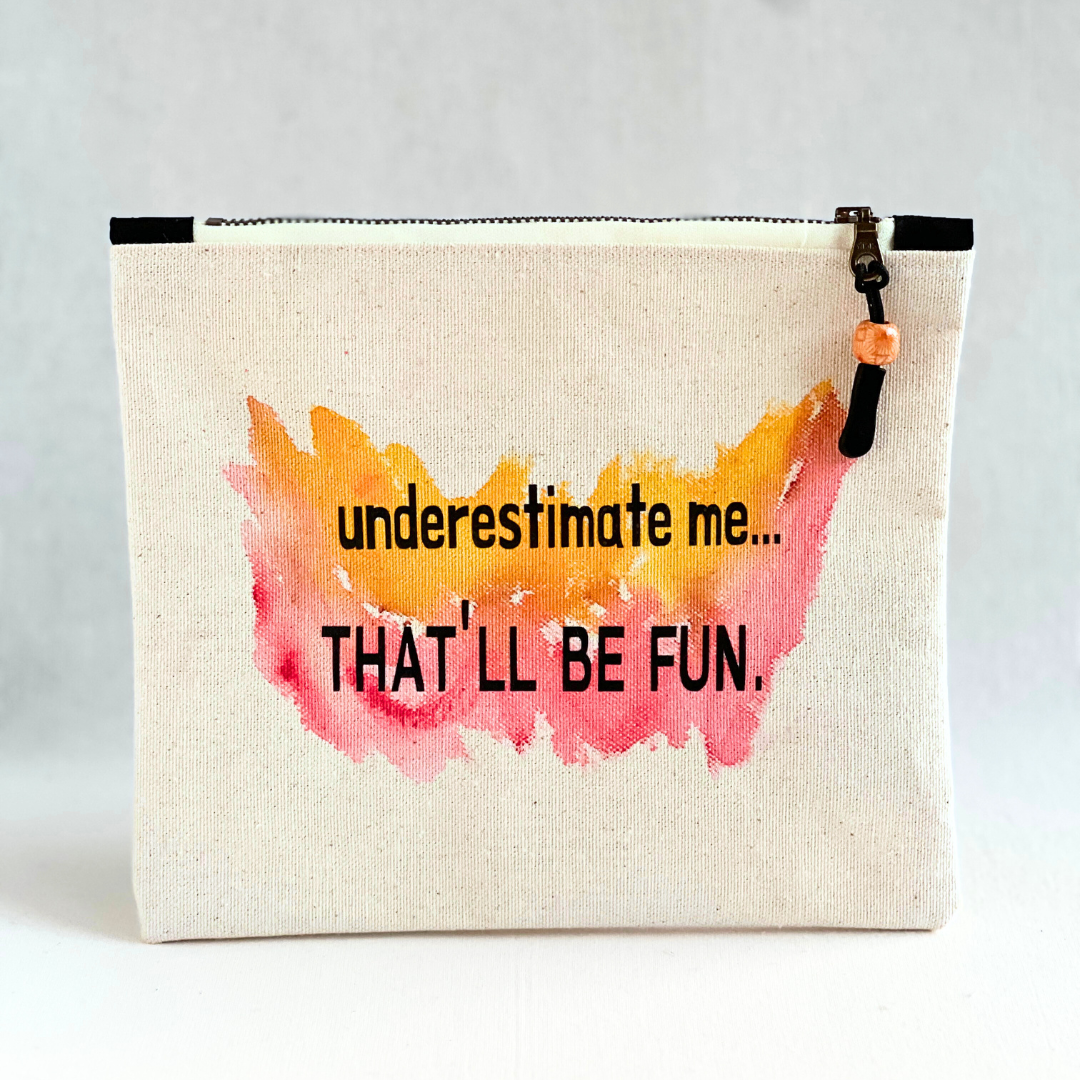 square canvas zipper bag with paint and the words, "underestimate me..that'll be fun.