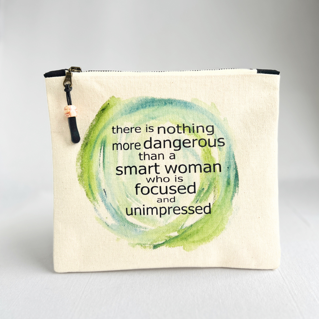 a square canvas zipper bag with the words, there is nothing more dangerous than a smart woman who is focused and unimpressed