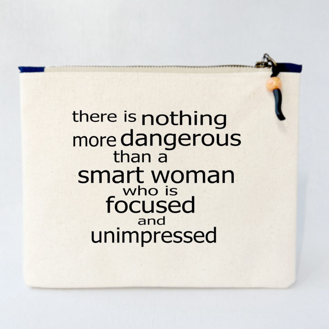 a square canvas zipper bag with the words, there is nothing more dangerous than a smart woman who is focused and unimpressed