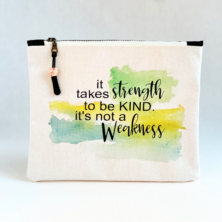 square canvas zipper pull bag with the words, it takes strength to be kind, it's not a weakness.