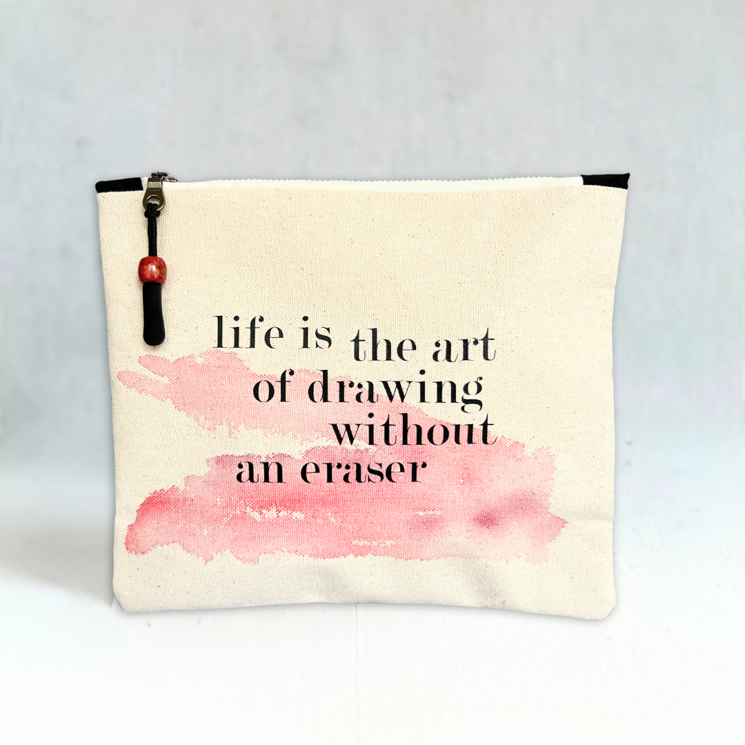 square canvas zipper pull bag with the words, life is the art of drawing without an eraser