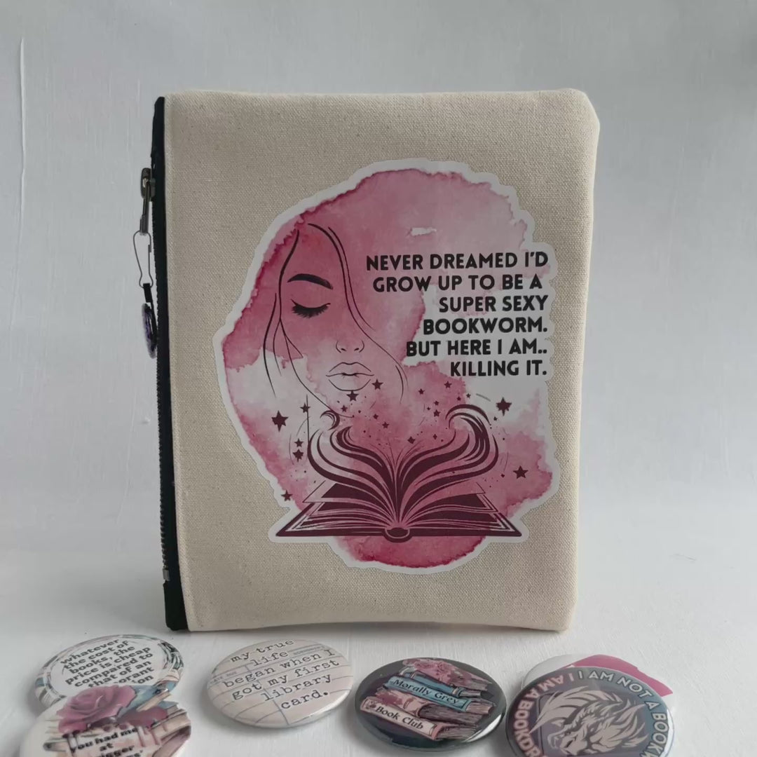 square oblong canvas zipper bag with a design of a face and an open book, with the words, "Never dreamed I'd grow up to be a super sexy bookworm. But here I am..killing it."