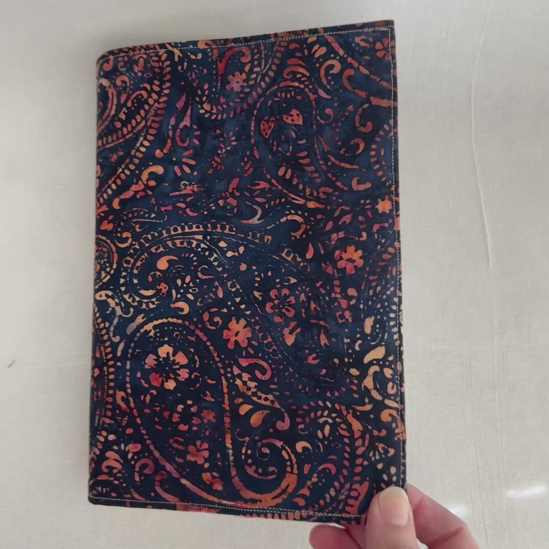 rectangular fabric book cover made of rich orange and yellow paisley on deep navy