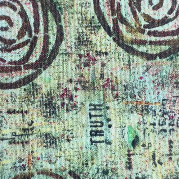 a book covered in a vibrant blue green fabric reusable  adjustable book cover.  Fabric has impressionist rose / concentric deep brown circles and the word ' TRUTH scattered on the pattern.