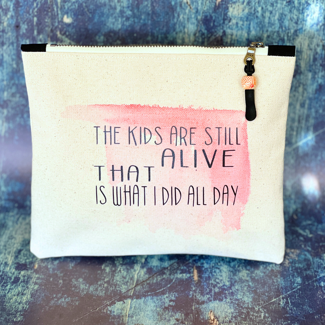a square canvas zip bag with pink watercolor swash and the words, "the kids are still alive. THAT is what I did all day." in black lettering