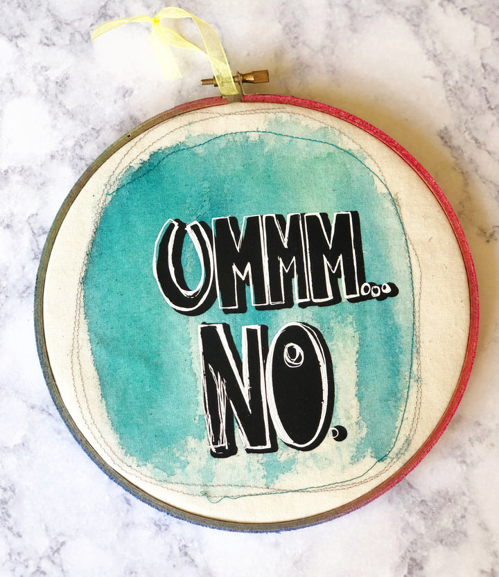 round wooden hoop with blue paint and the words, "ummm...no."