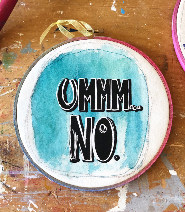 round wooden hoop with blue paint and the words, "ummm...no."
