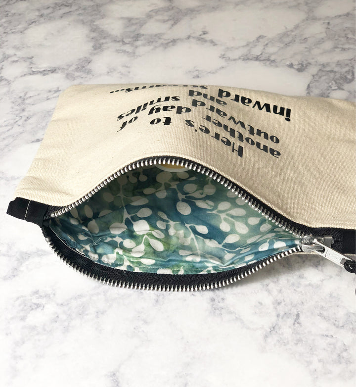 a cotton canvas zip bag, opened to show the lining inside the bag