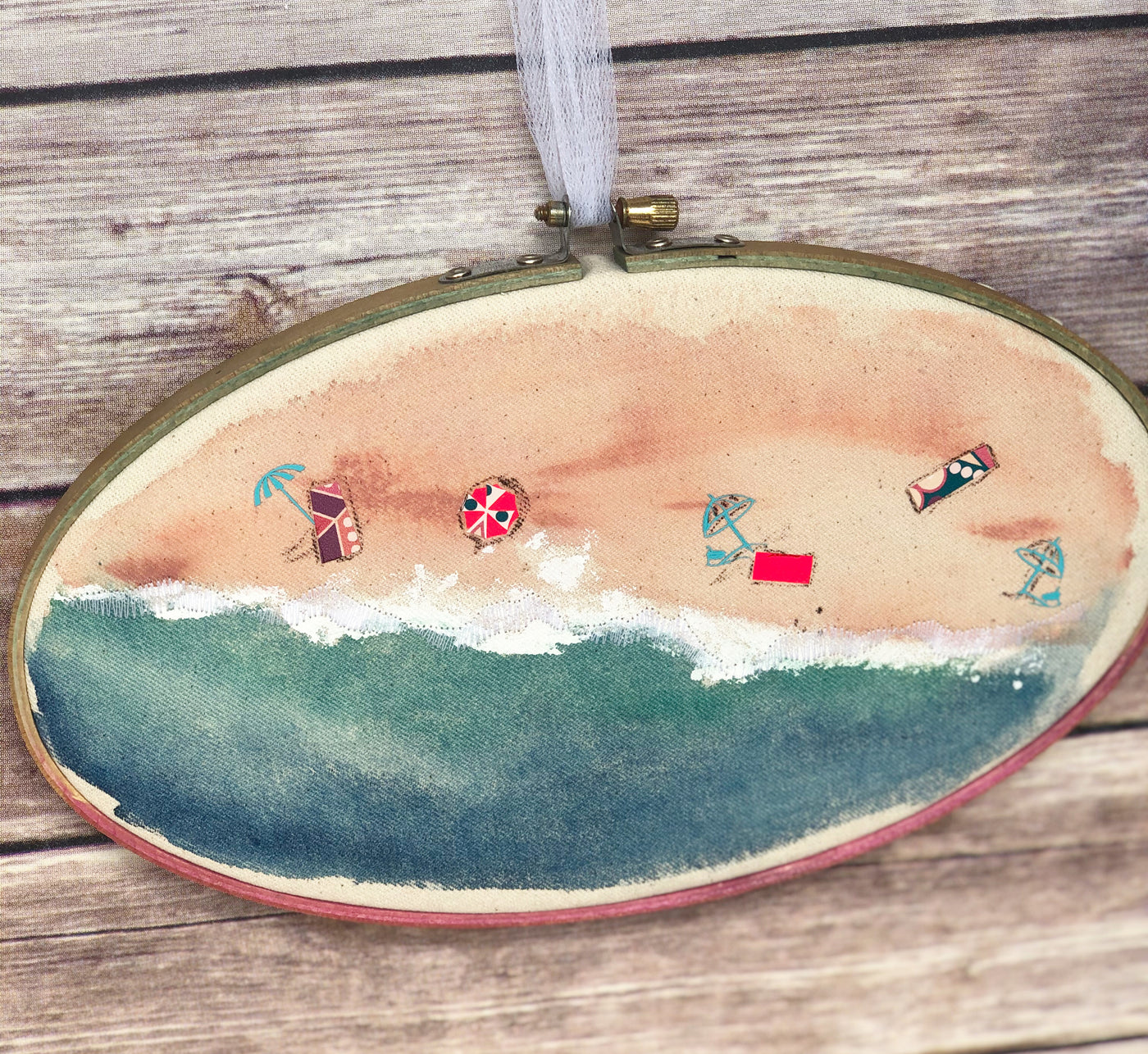 oval wooden dyed hoop art with fabric painted to look like the seashore