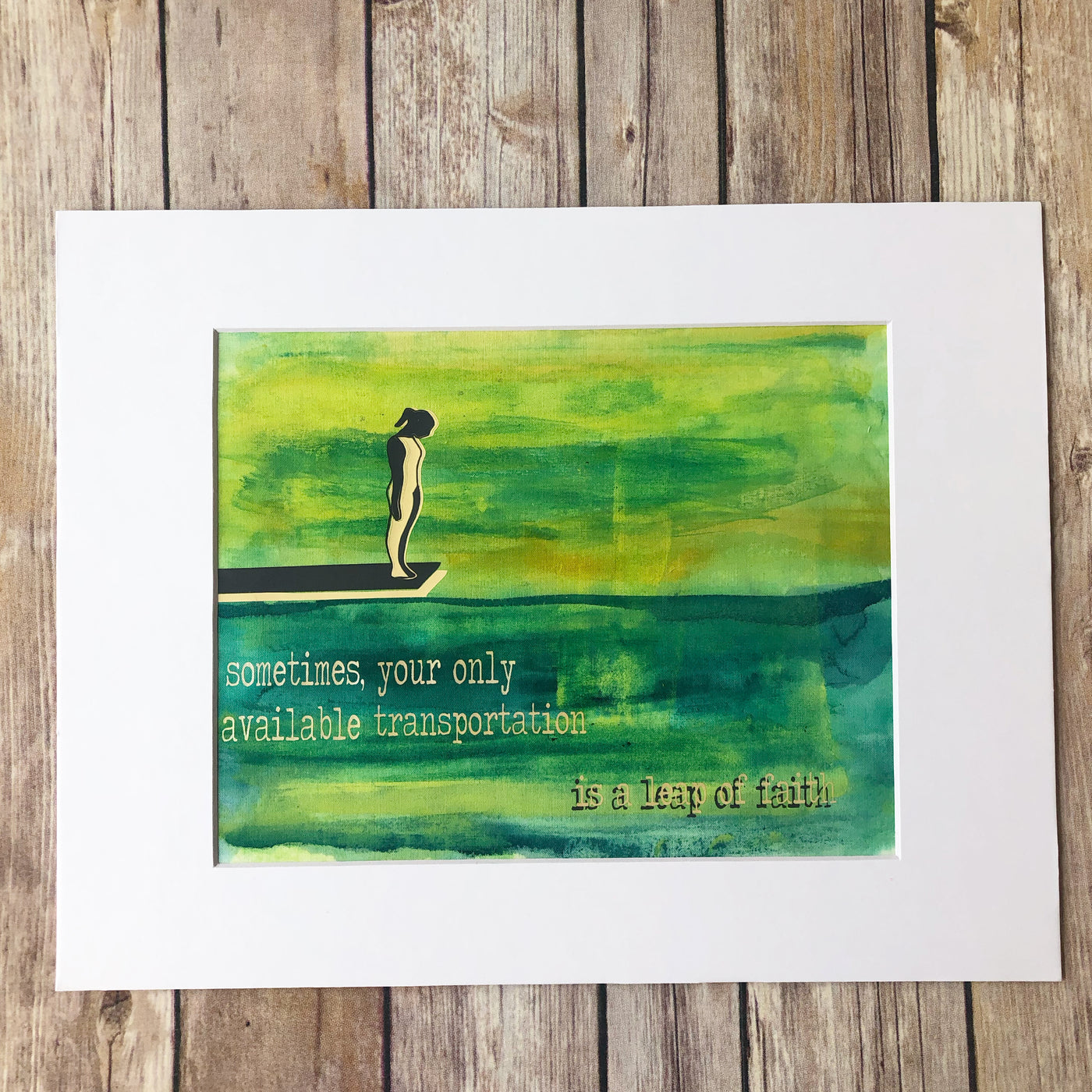 painted fabric art piece in green and blue paint, with a person on a diving board, and the words, "sometimes your only available transportation is a leap of faith