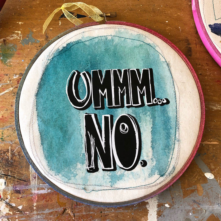 round wooden hoop with blue paint and the words, "ummm...no."