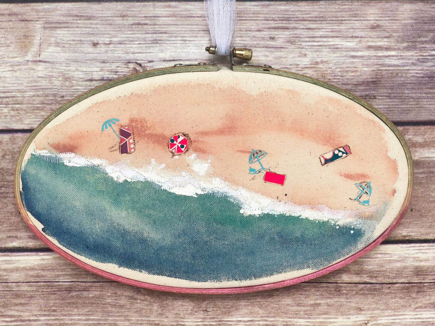 oval wooden dyed hoop art with fabric painted to look like the seashore