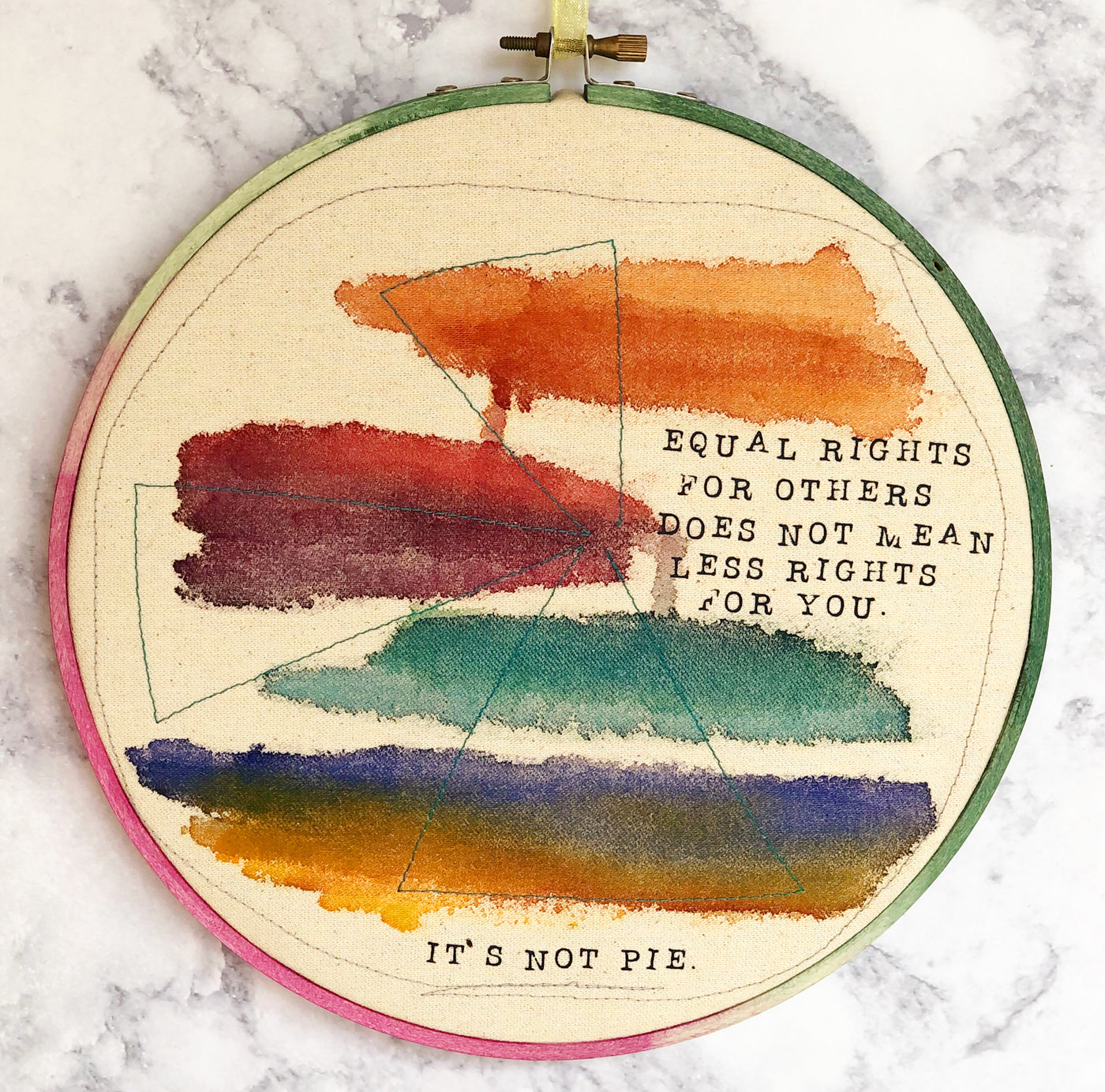 a round multicolored wooden hoop with the words, "equal rights for others does not mean less rights for you.. it's not pie."