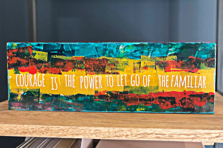 courage is the power to let go of the familiar - wood panel art