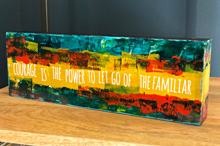 courage is the power to let go of the familiar - wood panel art