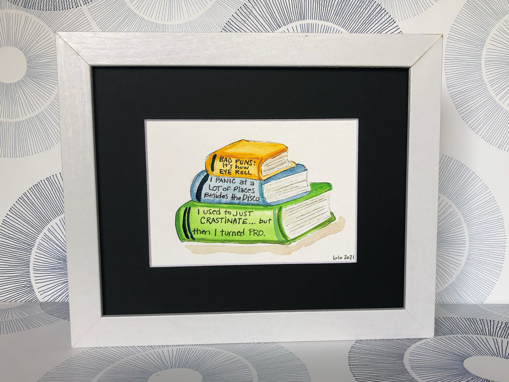 an original painted watercolor piece with three books in colors of burnt yellow, celery green and faded cerulean blue