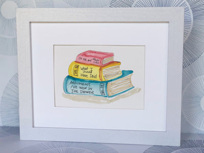 original watercolor painting of three books in red, yellow and blue