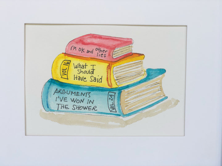 original watercolor painting of three books in red, yellow and blue