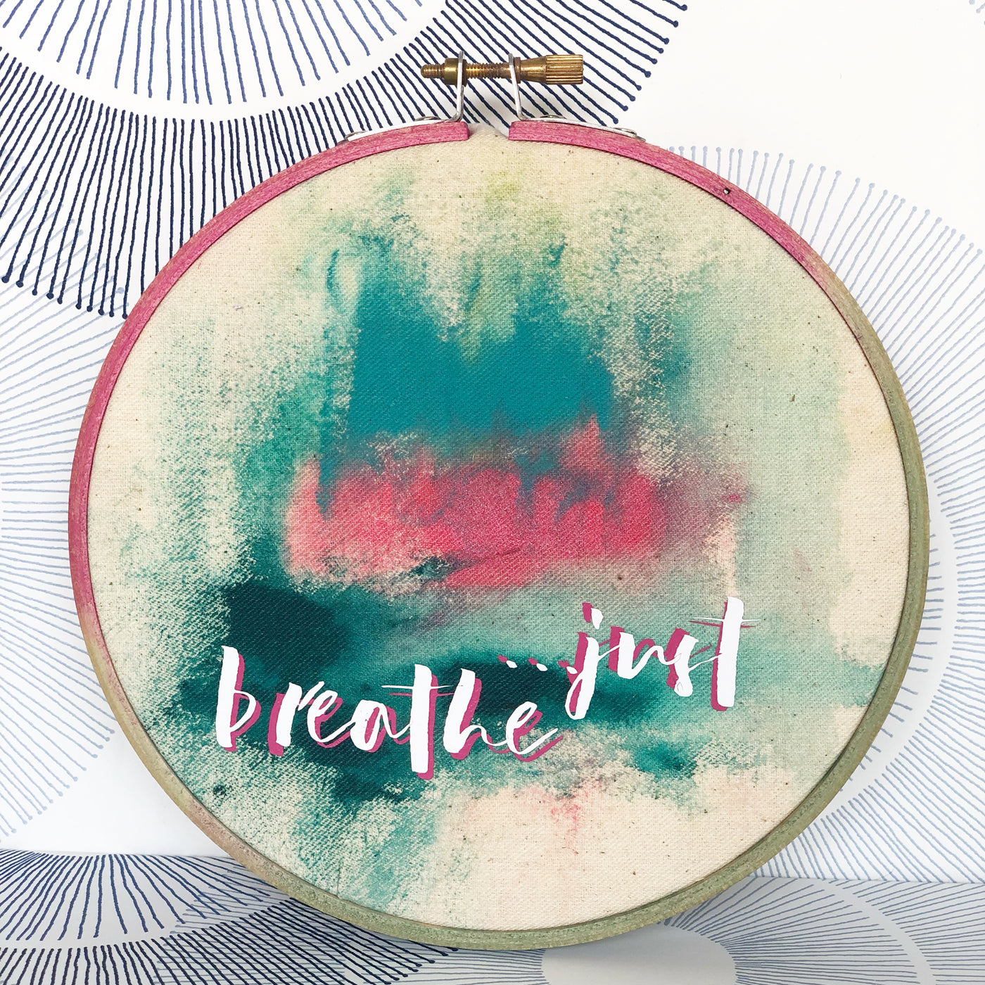 painted wooden hoop with fabric painting and the words, 'just breathe'