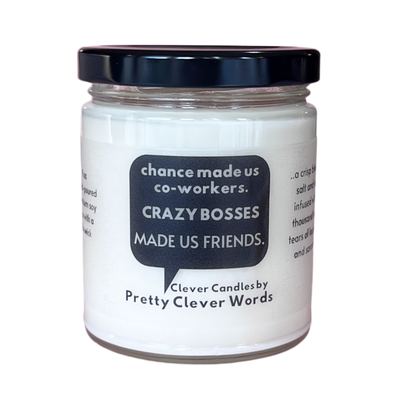 white candle with black lid and words in a black word bubble