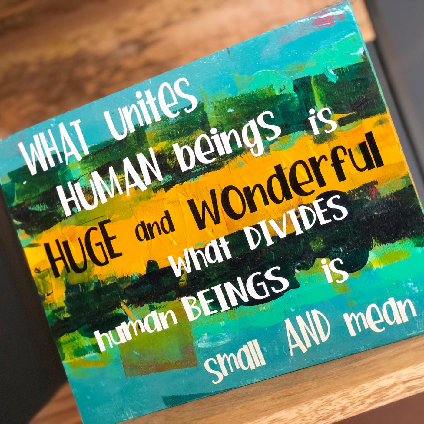 what unites human beings - wood panel art