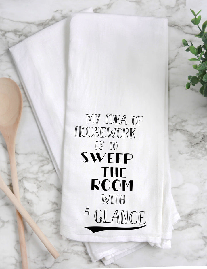 a white cotton kitchen towel with the words, "My idea of housework is to sweep the room with a glance."