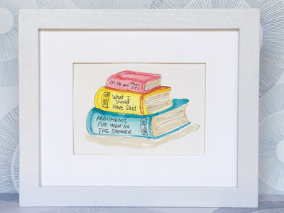 original watercolor painting of three books in red, yellow and blue