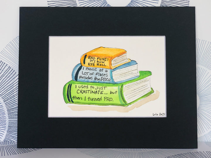 an original painted watercolor piece with three books in colors of burnt yellow, celery green and faded cerulean blue