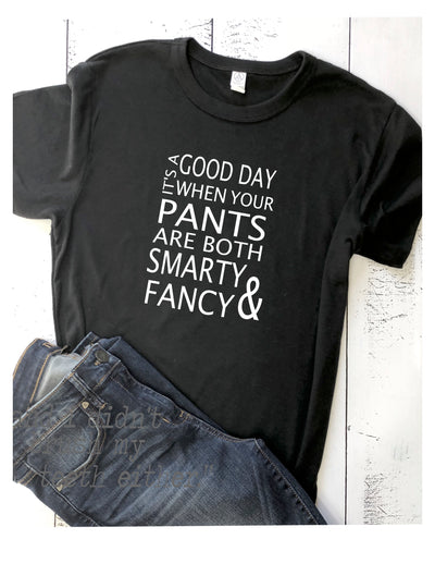 SCOOP NECK TEE with short sleeves is a relaxed fit, in the softest, lightest blend made of materials produced in the US.  It has a wonderfully fitted look, yet has some stretch that helps the material skim your sides.  This shirt runs true to size with slightly fitted sleeves - size up for a looser fit. The shirt is black with white lettering and the lettering says it's a good day when your pants are both smarty and fancy