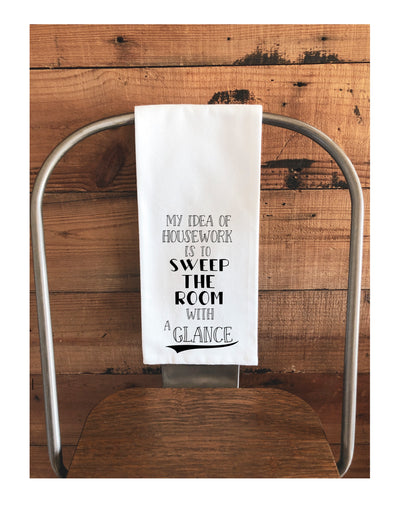 a white cotton kitchen towel with the words, "My idea of housework is to sweep the room with a glance."